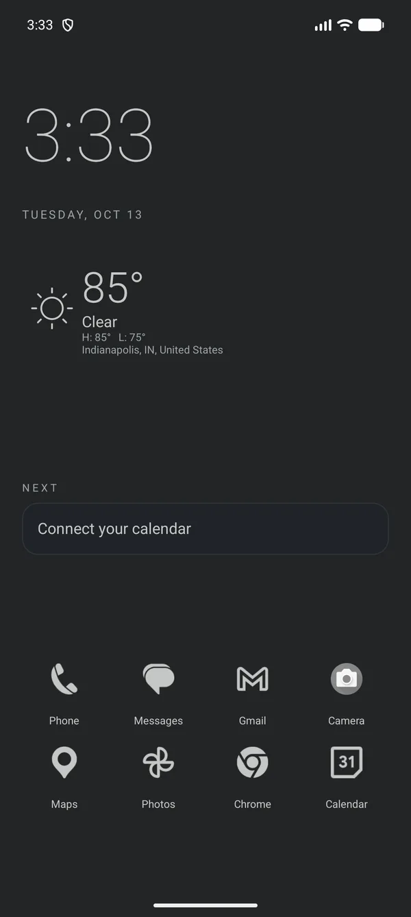 Graphite Flat home screen on an Android emulator with a large clock, current weather for Indianapolis (85°, clear), a calendar prompt and a monochrome app dock